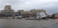 River Club Restaurant, which sustained major damage is on the left. "A houseboat, owned by Jerry Donnellan" on the right, was a total loss.